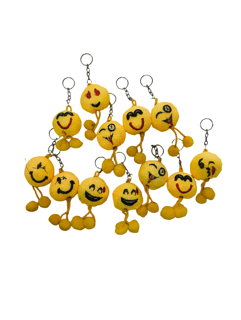 Set of yellow emoji keychains with various facial expressions on a white background