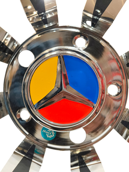 Close-up of a Mercedes-Benz emblem on a truck hubcap with a white background