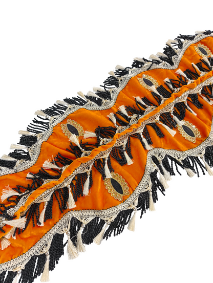 Decorative orange fabric with black and white patterns on a white background