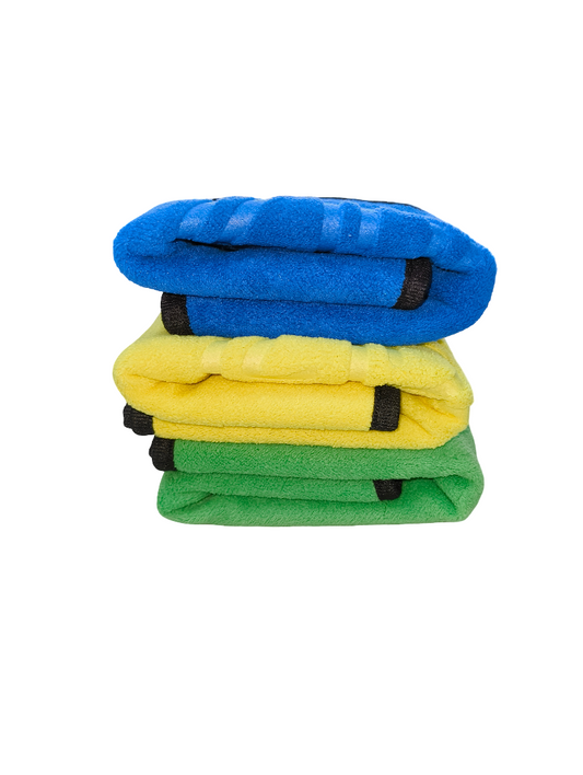 Stack of three folded towels in blue, yellow, and green on a white background